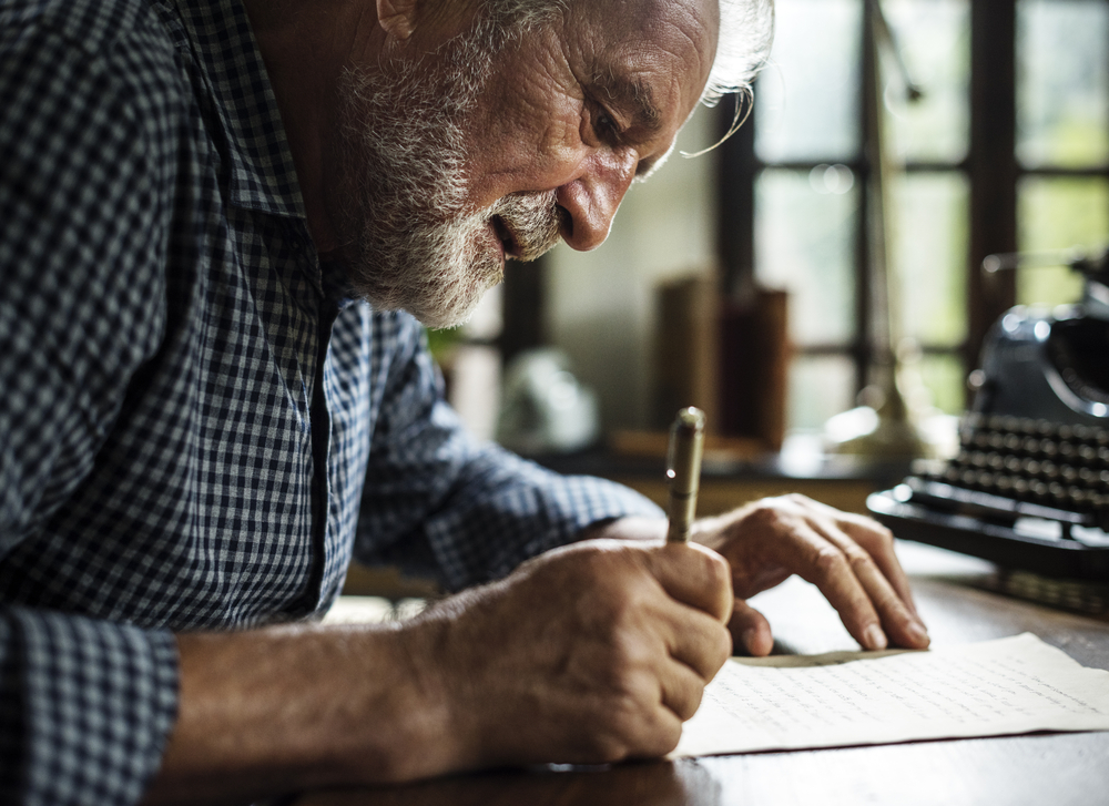 Closeup,Of,Senior,Man,Writing,Letter