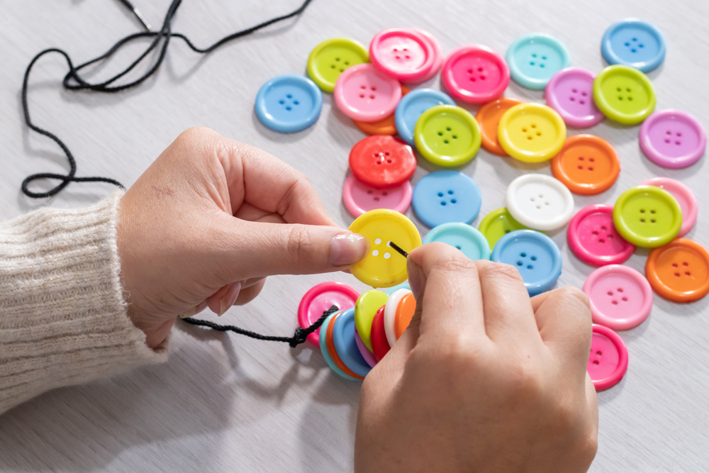 Hands Holding a Colourful Button