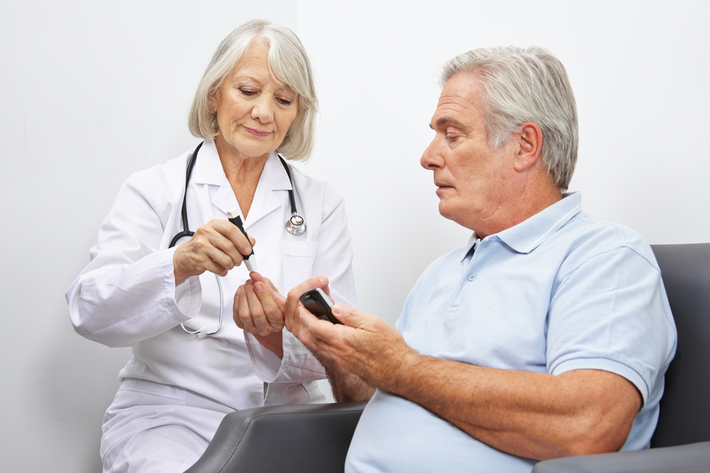 Doctore making blood-sugar test for Senior man