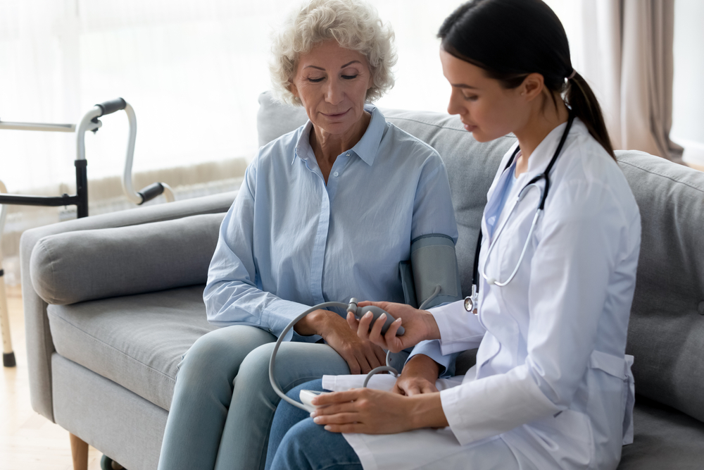 Female Physician caring about Old Woman