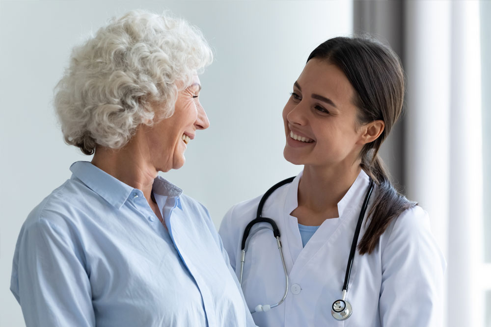 caregiver helping elderly patient