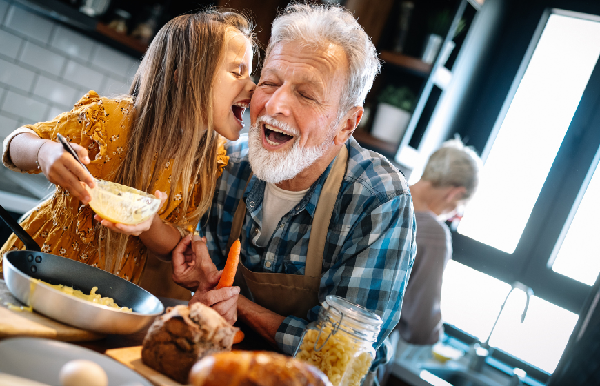 Grandfather and his grandchildren in kitchen together with meal prep and delivery for seniors