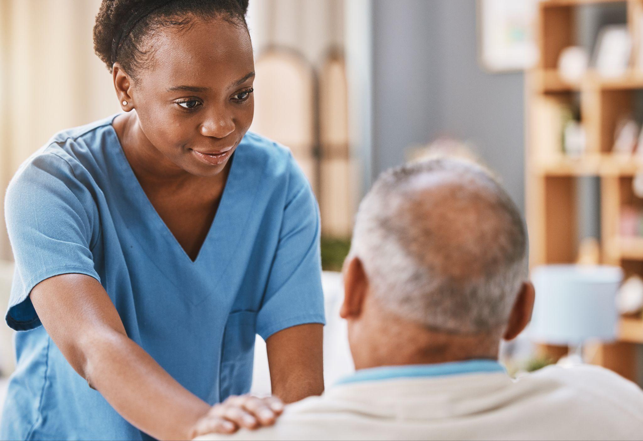 Home Health Aide helping an elderly client at home